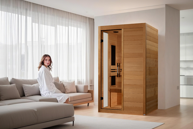 Woman in a robe sitting on a couch next to a wooden sauna in a modern living room.