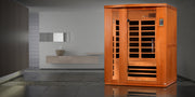 Wooden sauna in a modern room with gray walls and a small table.