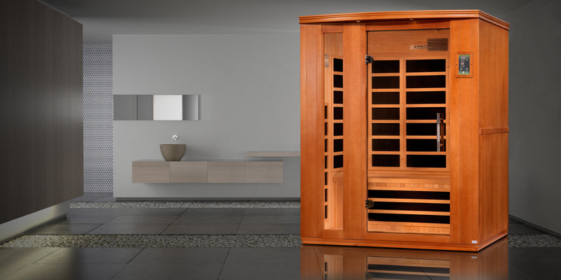Wooden sauna in a modern room with gray walls and a small table.
