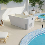 White outdoor cold plunge unit in a modern patio setting with pool and chairs.